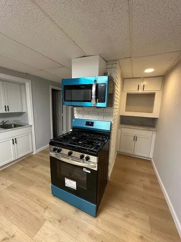 a kitchen with stainless steel appliances a stove a sink and a microwave