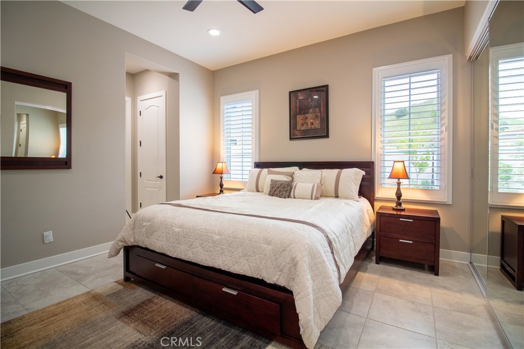51 Egret Irvine, CA 92618 - Photo 11 of 24 a spacious bedroom with a bed and a table