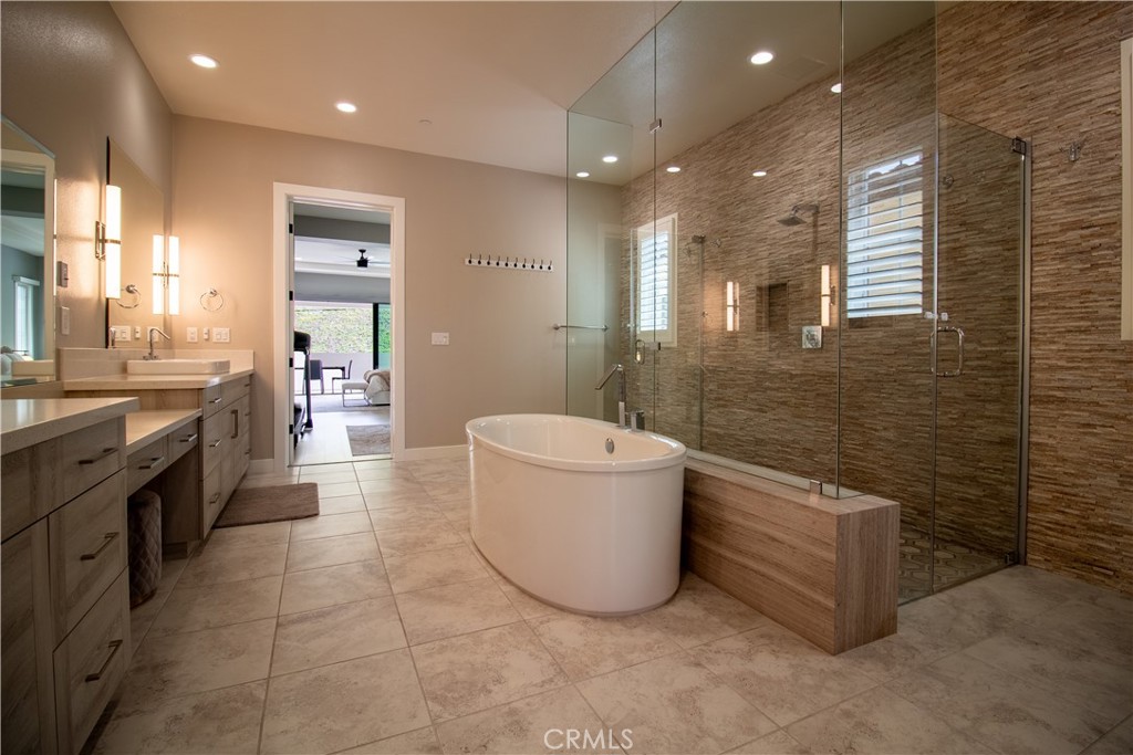 51 Egret Irvine, CA 92618 - Photo 13 of 24 a large bathroom with a tub a sink and mirror