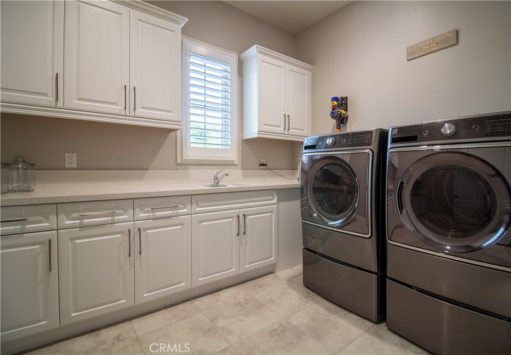 51 Egret Irvine, CA 92618 - Photo 19 of 24 a utility room with sink dryer and washer