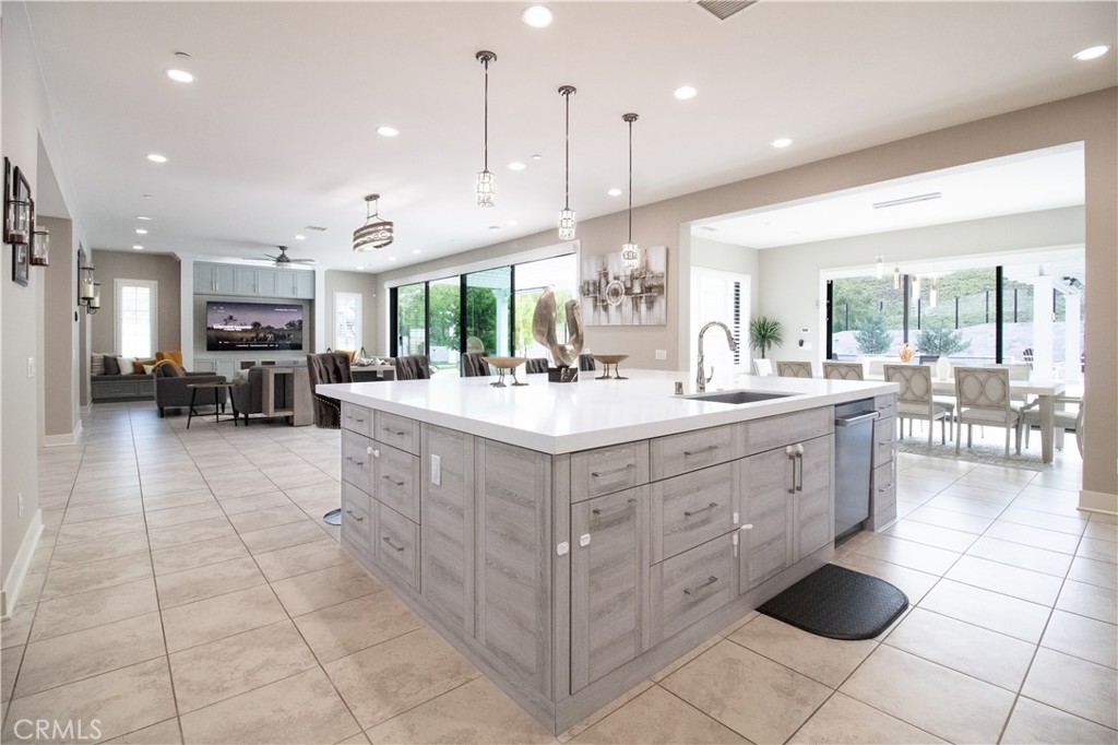 51 Egret Irvine, CA 92618 - Photo 8 of 24 a large white kitchen with a large window and chairs