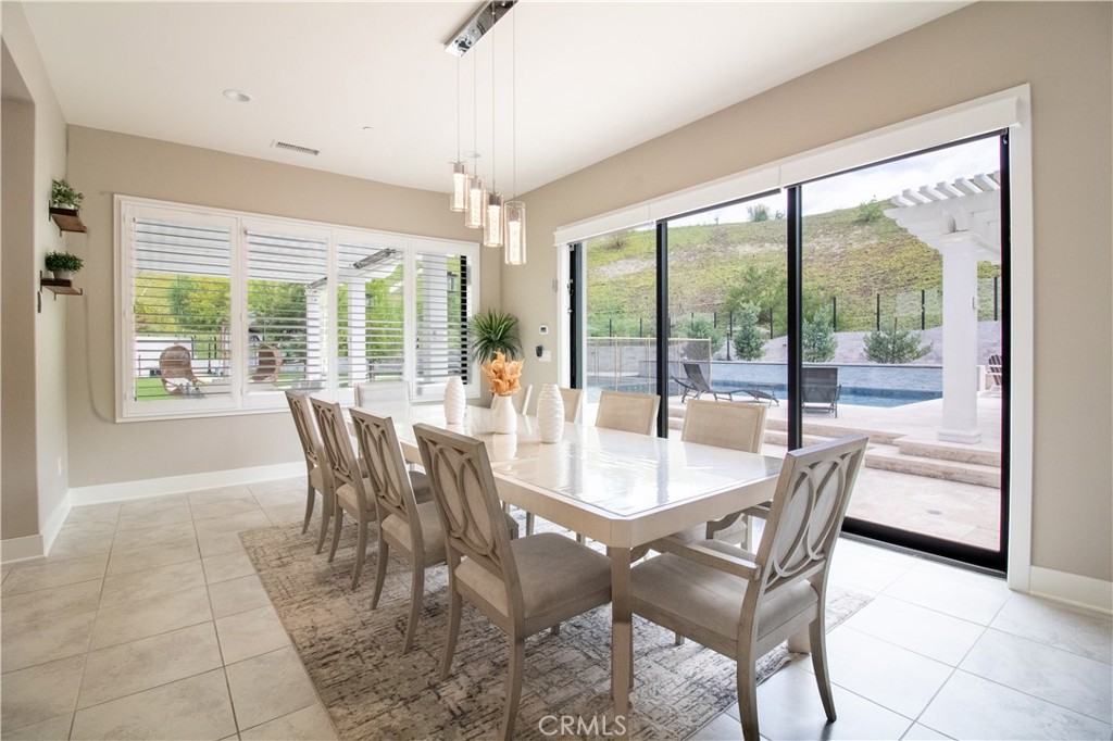 51 Egret Irvine, CA 92618 - Photo 9 of 24 a view of a dining room with furniture large windows and wooden floor