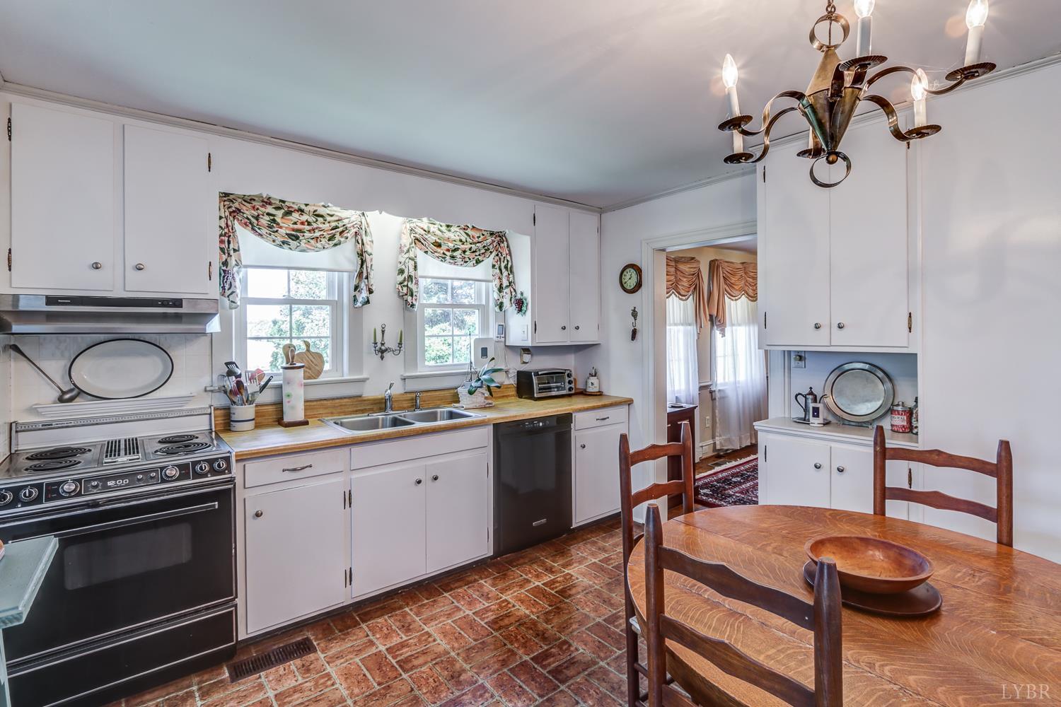 129 Lawyers Road Red House, VA 23963 - Photo 29 of 72 a kitchen with a stove a sink and a refrigerator
