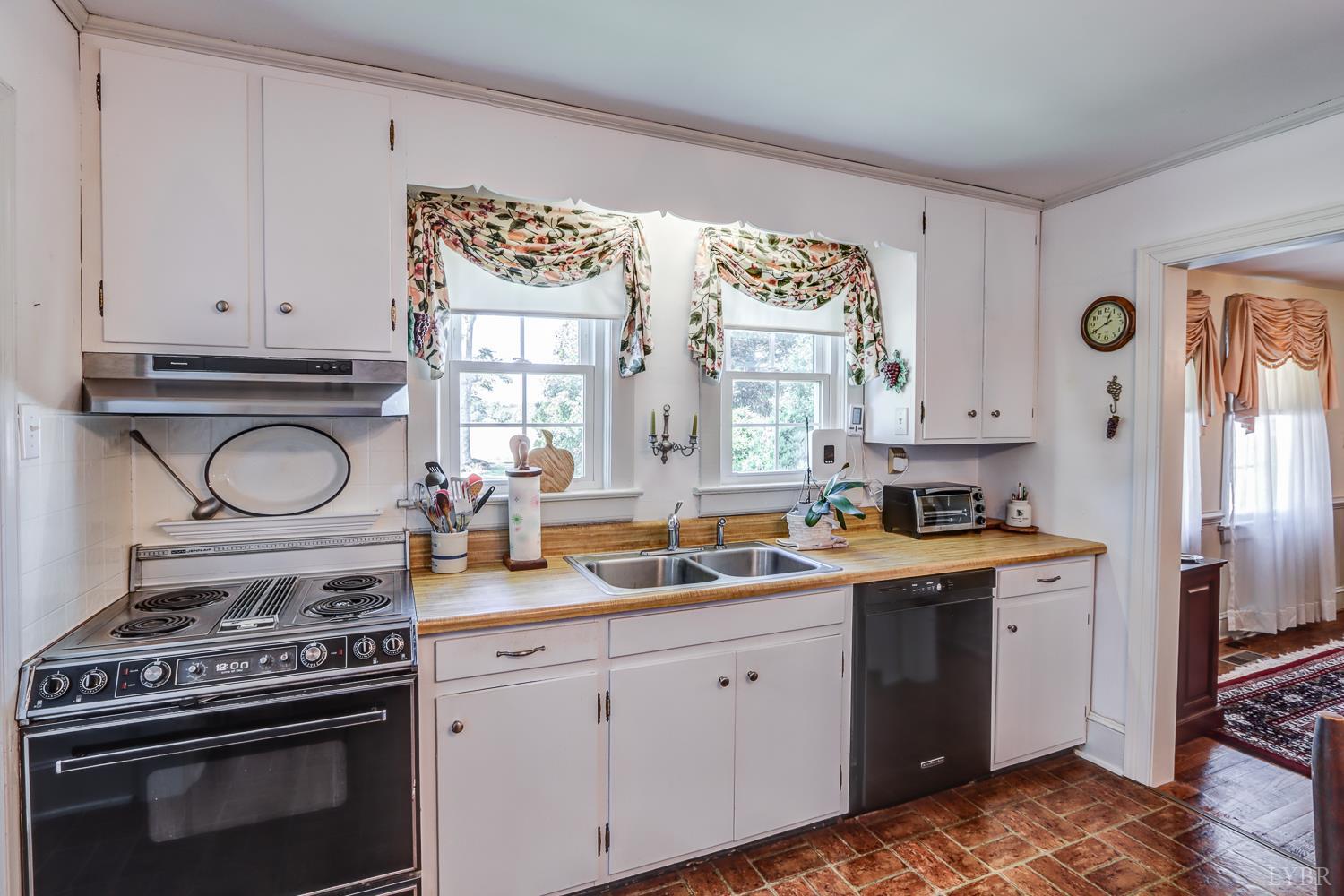 129 Lawyers Road Red House, VA 23963 - Photo 31 of 72 a kitchen with a stove a sink and a window