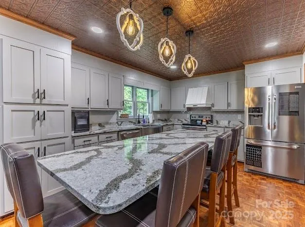 a kitchen with stainless steel appliances granite countertop a sink window and cabinets