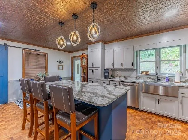 a kitchen with a dining table chairs and cabinets