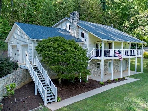 a front view of a house with a yard and potted plants