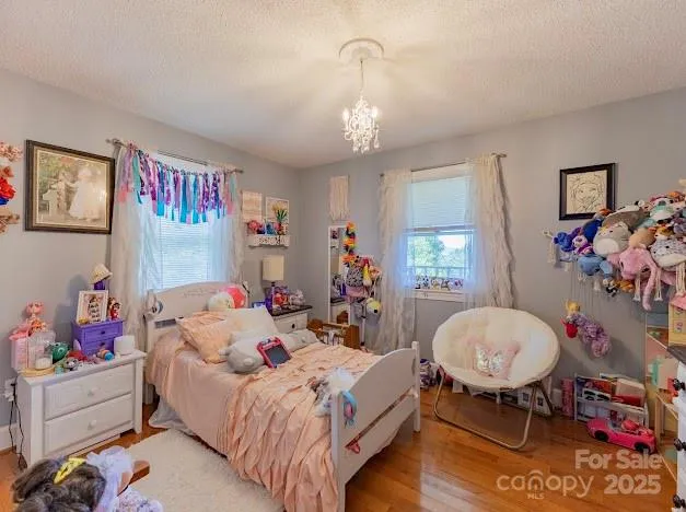 a bed room with a bed mirror and a window