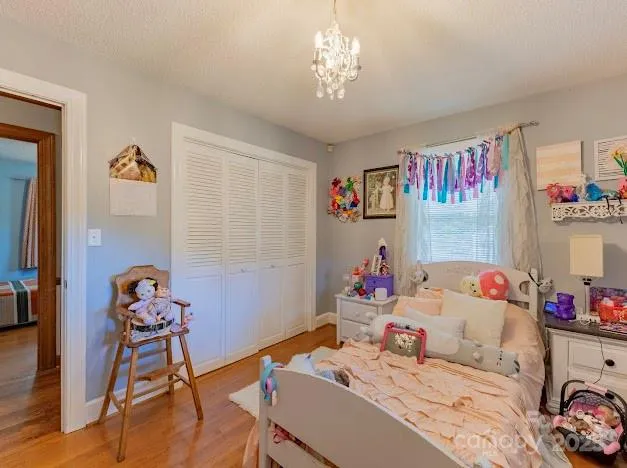 a bedroom with furniture and a wooden floor