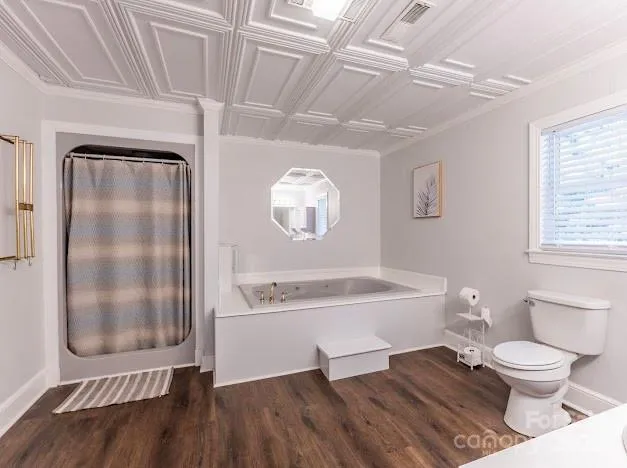 a spacious bathroom with a toilet a sink and mirror