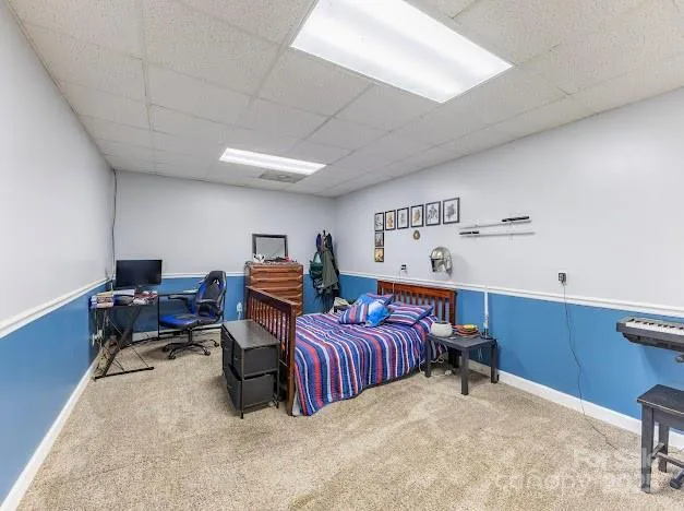 a bedroom with furniture and a large window