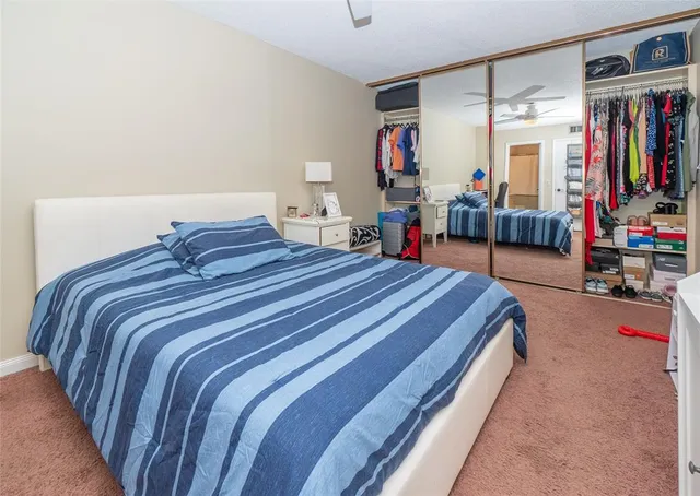 a bedroom with bed and a book shelf