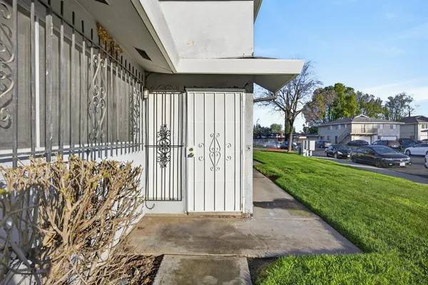 a view of a house with a small yard and plants