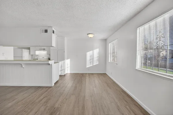 a view of kitchen with wooden floor and electronic appliances