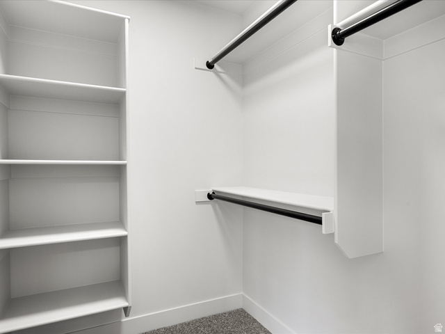 1159 North Broad Hollow Road Garden City, UT 84028 - Photo 47 of 55 Walk-in closet featuring built-in shelving, white walls, and dark-finish hanging rods