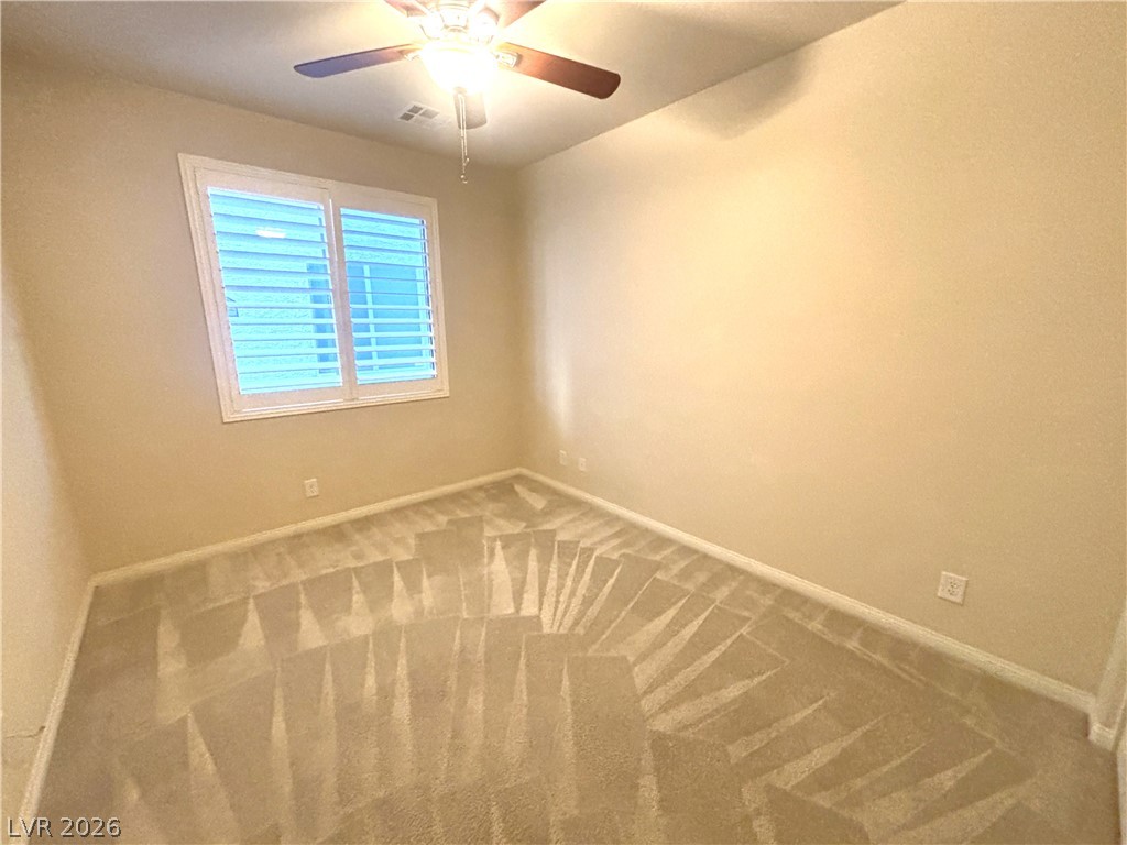 121 Elm Reed Avenue Las Vegas, NV 89113 - Photo 26 of 30 An inviting room offering soft carpet flooring and a ceiling fan, creating a comfortable atmosphere.