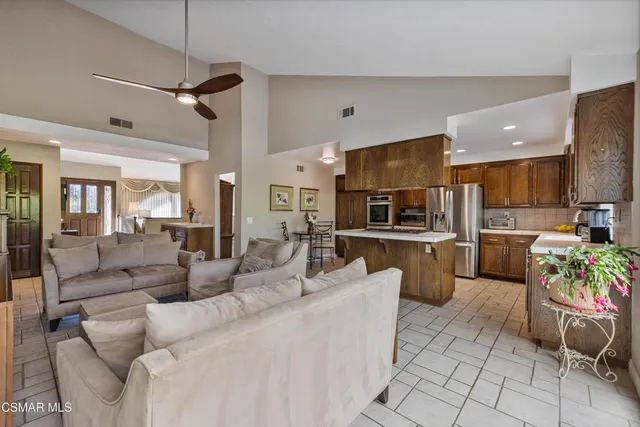 a living room with furniture and kitchen view