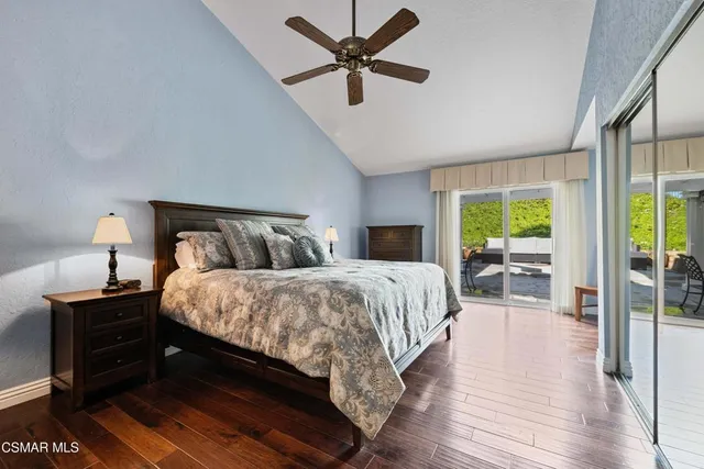 a bedroom with a large bed and a chandelier