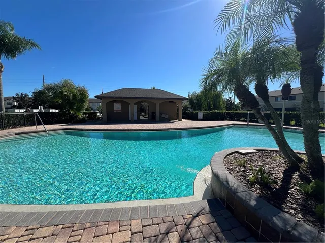 a view of a garden with a table and chairs