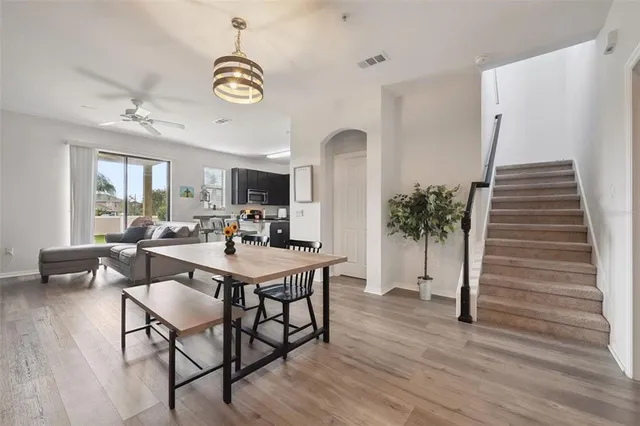 a view of a a dining room with furniture window and wooden floor