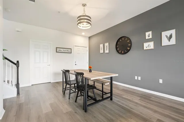 a view of a dining room with furniture and wooden floor