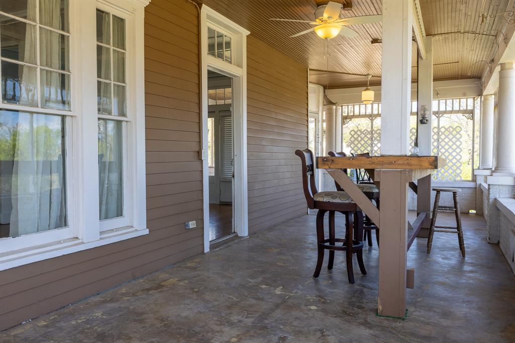 1115 Austin Street Coleman, TX 76834 - Photo 27 of 40 a view of a dining room with furniture and wooden floor