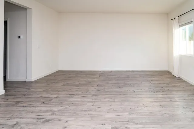 a view of wooden floor and white walls