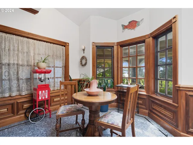 a view of a dining room with furniture a chandelier and wooden floor