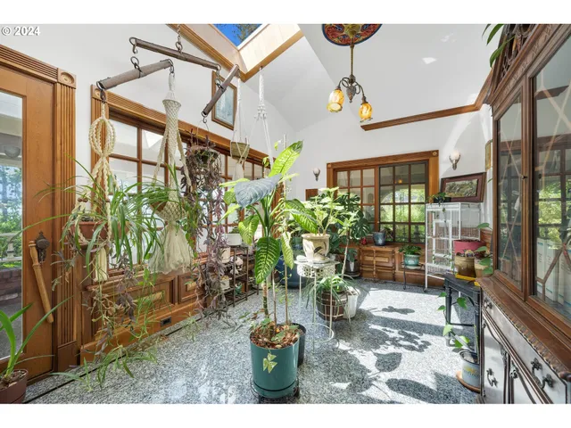 a view of a porch with furniture and garden