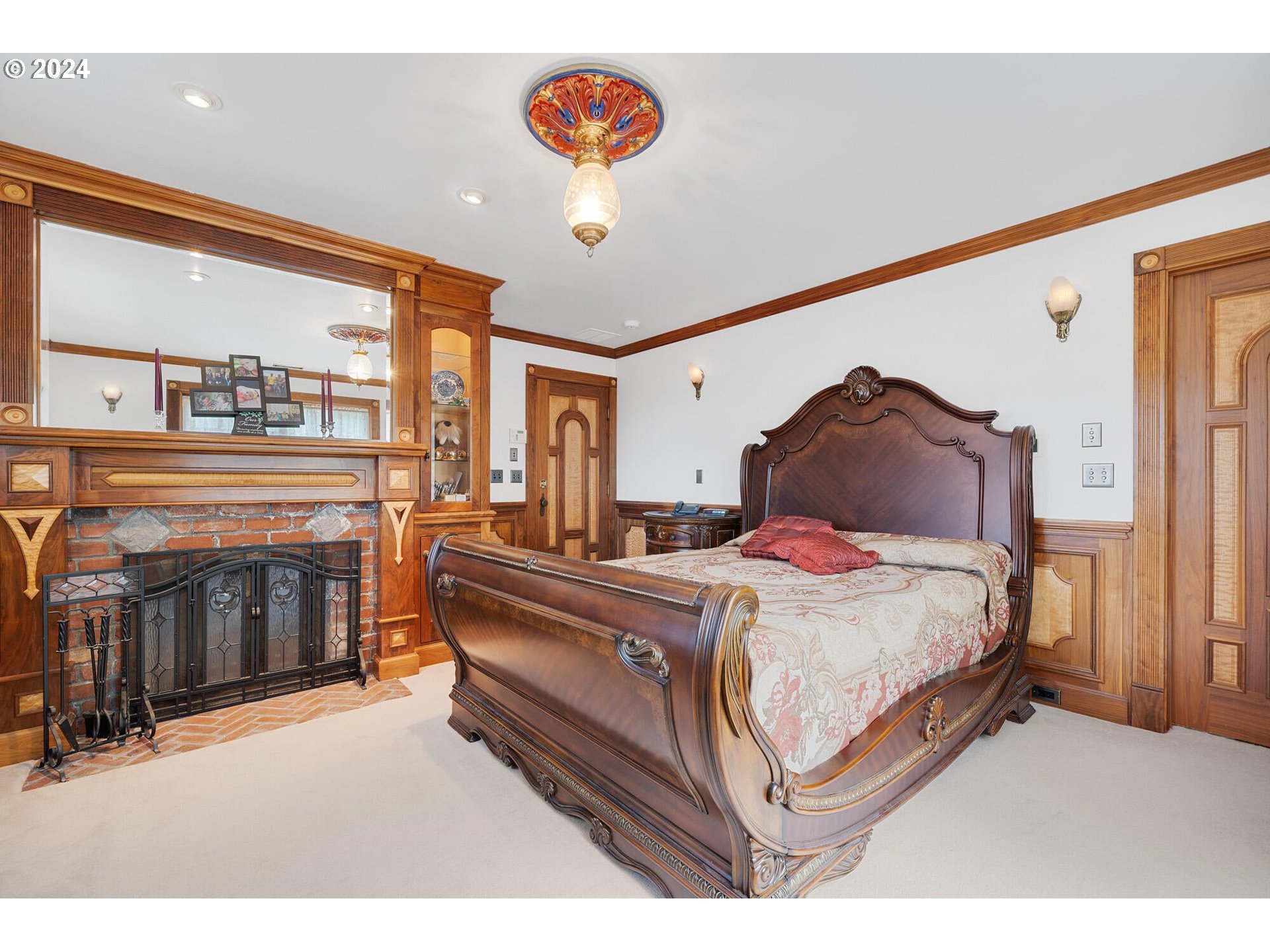 11250 Whiskey Creek Road Tillamook, OR 97141 - Photo 22 of 48 a spacious bedroom with a bed and a fireplace