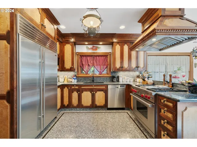 a kitchen with stainless steel appliances granite countertop a stove a sink and dishwasher