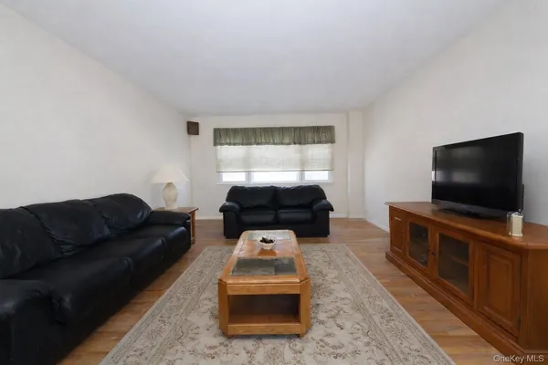 a large kitchen with a large counter top space appliances and cabinets