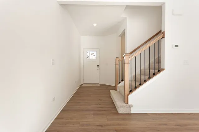 a view of a hallway with wooden floor