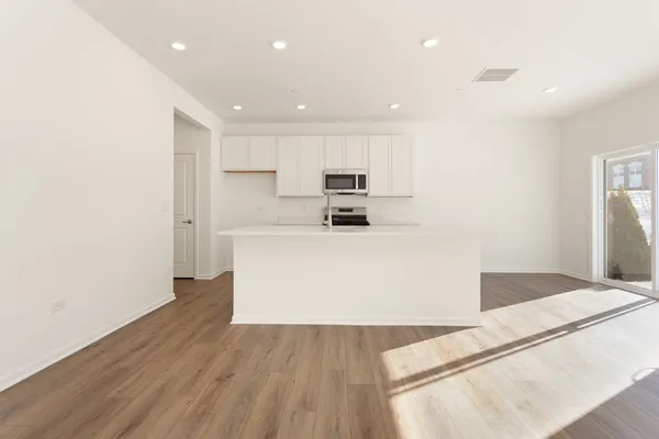 a view of a kitchen with wooden floor