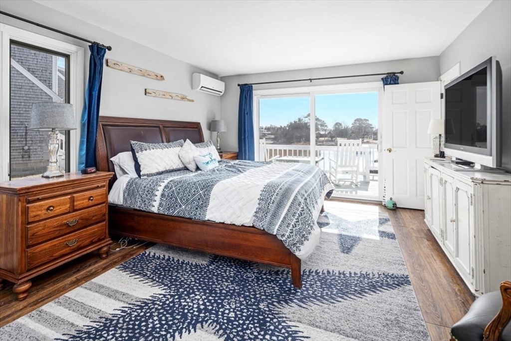 36 Benedict Road Bourne, MA 02532 - Photo 11 of 31 a bedroom with a bed and a flat tv screen on dresser
