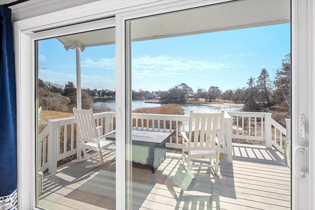 36 Benedict Road Bourne, MA 02532 - Photo 12 of 31 a view of a balcony with wooden floor and iron stairs