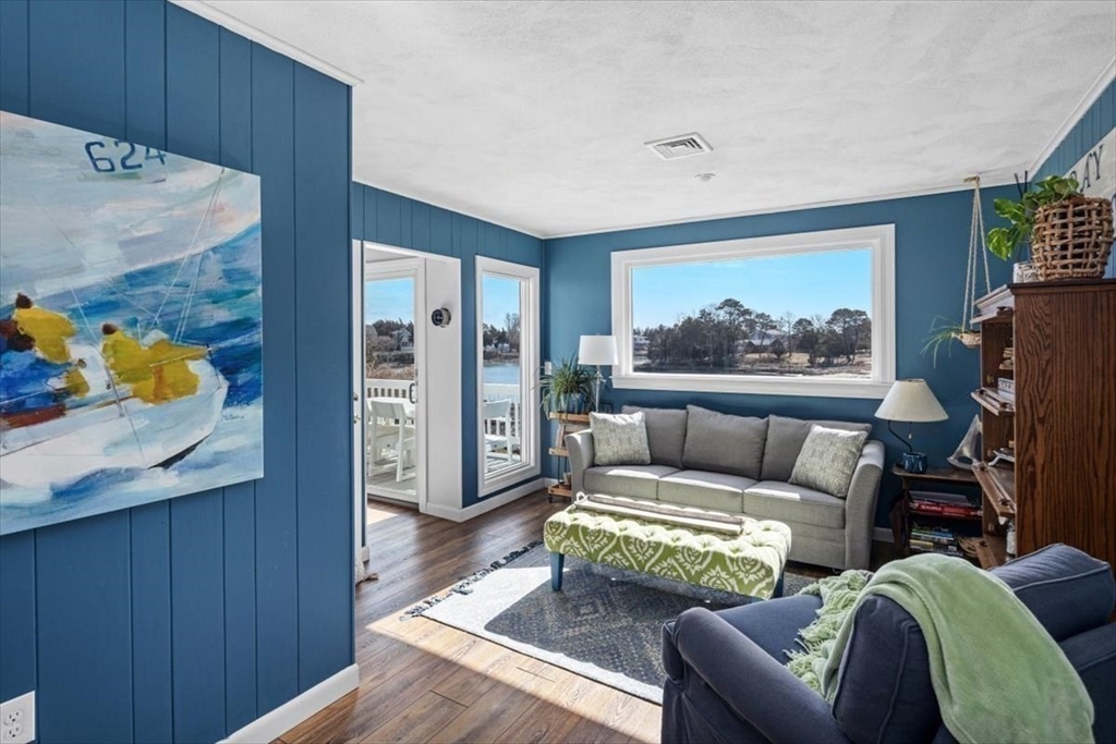 36 Benedict Road Bourne, MA 02532 - Photo 15 of 31 a living room with furniture and a wall painting