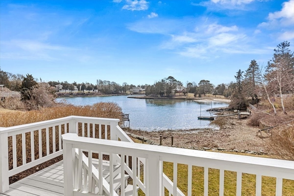 36 Benedict Road Bourne, MA 02532 - Photo 23 of 31 a view of a wooden deck and lake