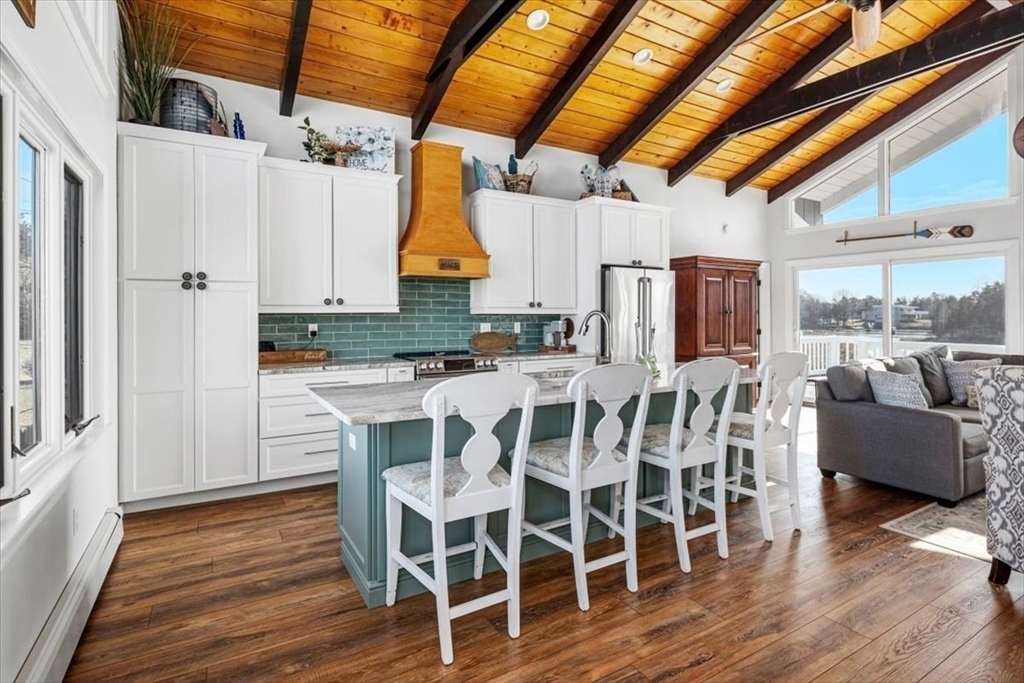 36 Benedict Road Bourne, MA 02532 - Photo 6 of 31 a kitchen with stainless steel appliances a dining table chairs and wooden floor