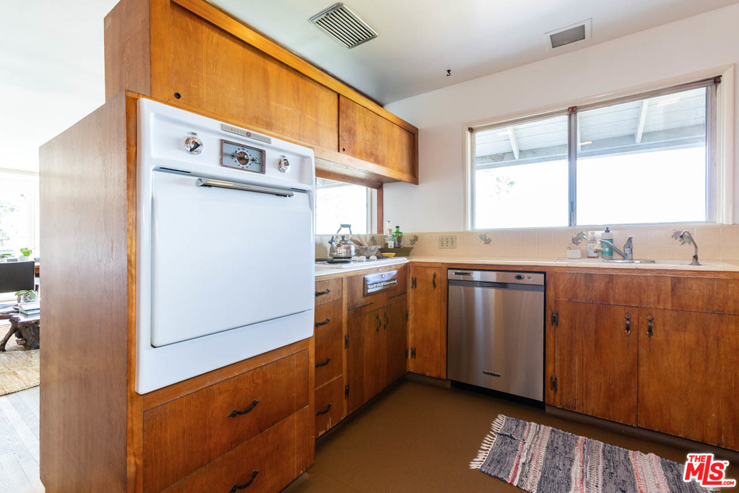 988 West Avenue 37 Los Angeles, CA 90065 - Photo 15 of 53 a kitchen with cabinets a window and stainless steel appliances