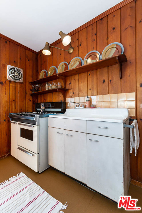 988 West Avenue 37 Los Angeles, CA 90065 - Photo 31 of 53 a kitchen with a stove and a white refrigerator