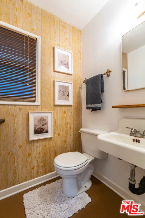 988 West Avenue 37 Los Angeles, CA 90065 - Photo 38 of 53 a bathroom with a toilet a sink and mirror