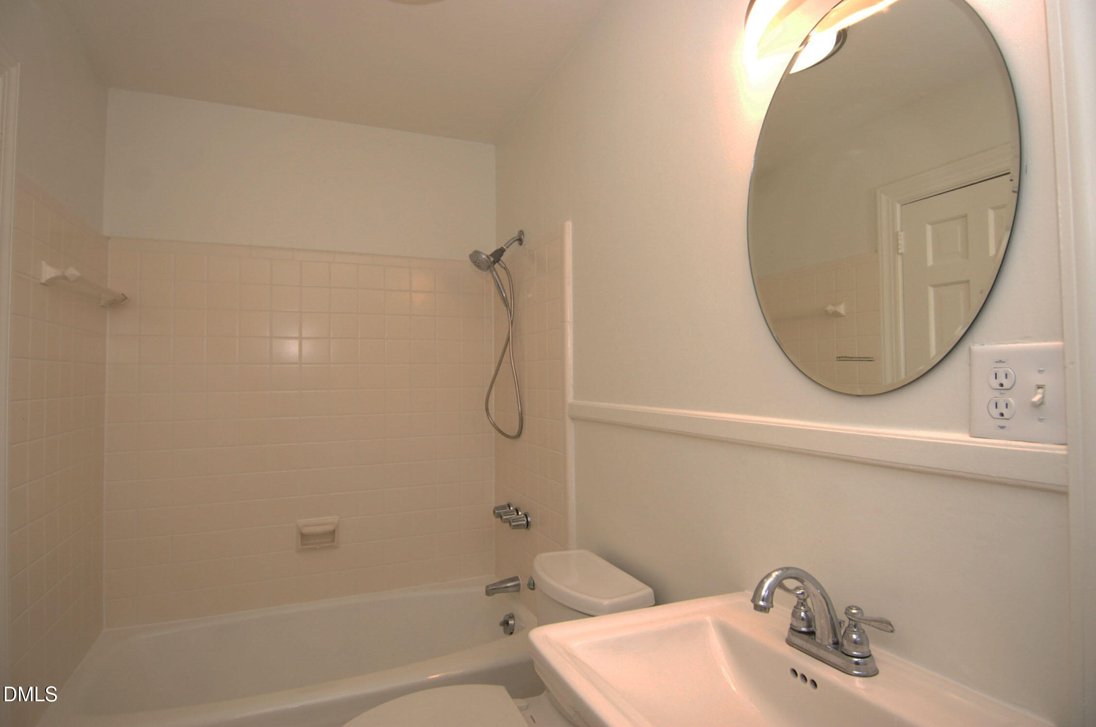 3225 Darien Drive Raleigh, NC 27607 - Photo 12 of 20 a bathroom with a sink a toilet and a mirror