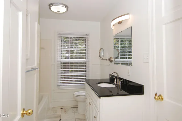 a bathroom with a sink double vanity and a window