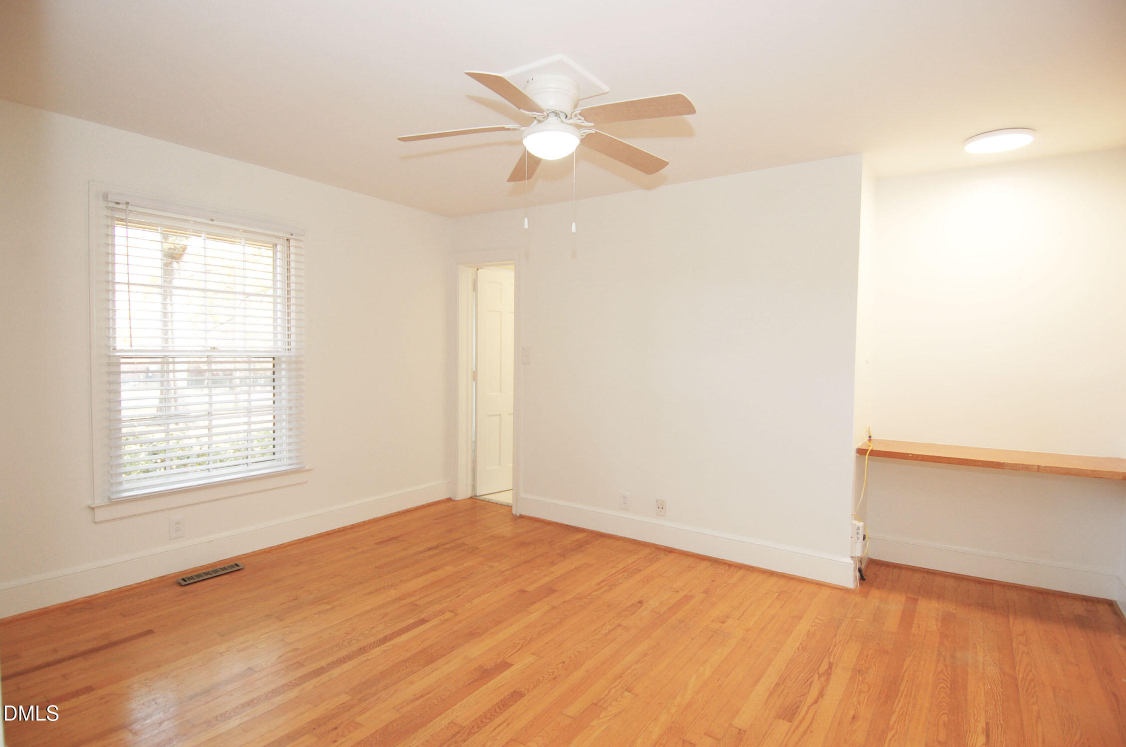 3225 Darien Drive Raleigh, NC 27607 - Photo 17 of 20 an empty room with wooden floor and windows