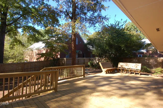 a view of house with deck and outdoor space