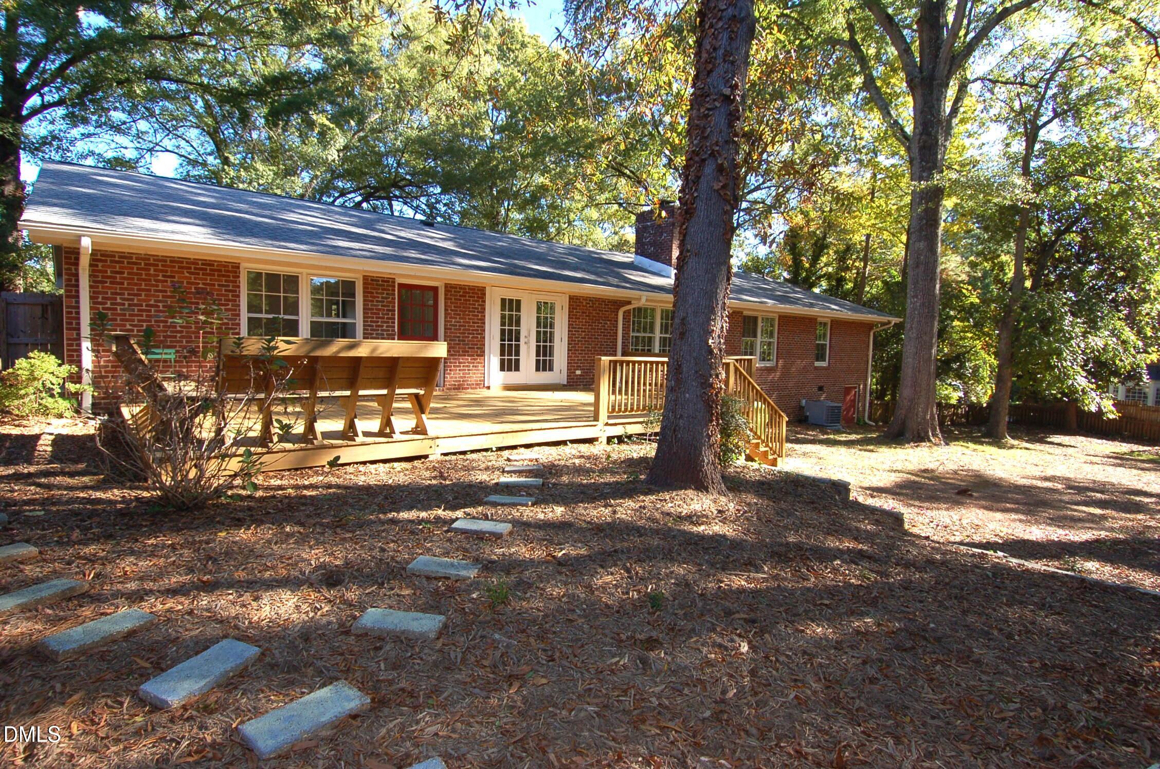 3225 Darien Drive Raleigh, NC 27607 - Photo 20 of 20 a front view of a house with a yard tree and outdoor seating