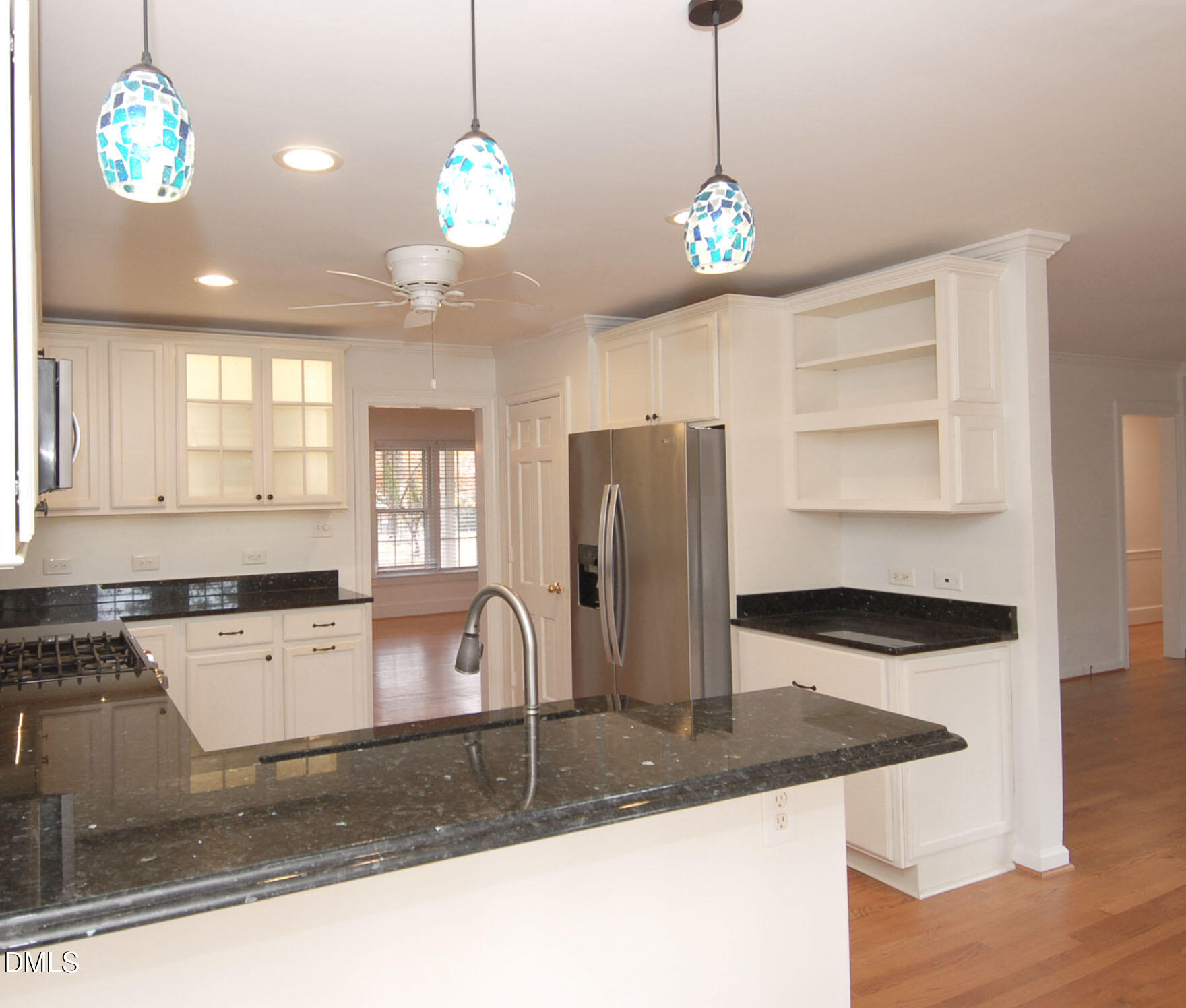 3225 Darien Drive Raleigh, NC 27607 - Photo 2 of 20 a kitchen with stainless steel appliances granite countertop a sink a stove and a wooden floors