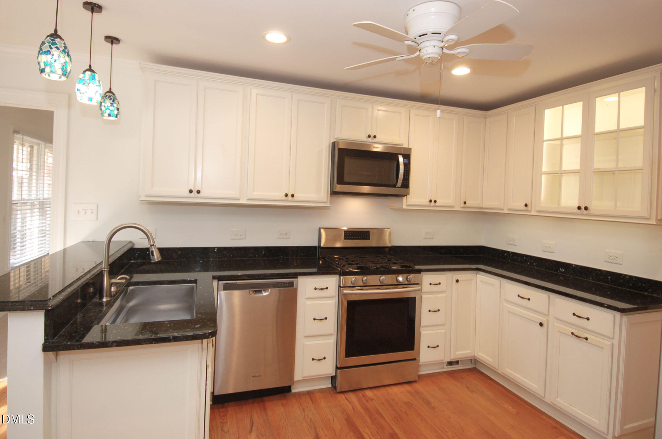 3225 Darien Drive Raleigh, NC 27607 - Photo 3 of 20 a kitchen with stainless steel appliances granite countertop a sink and a stove