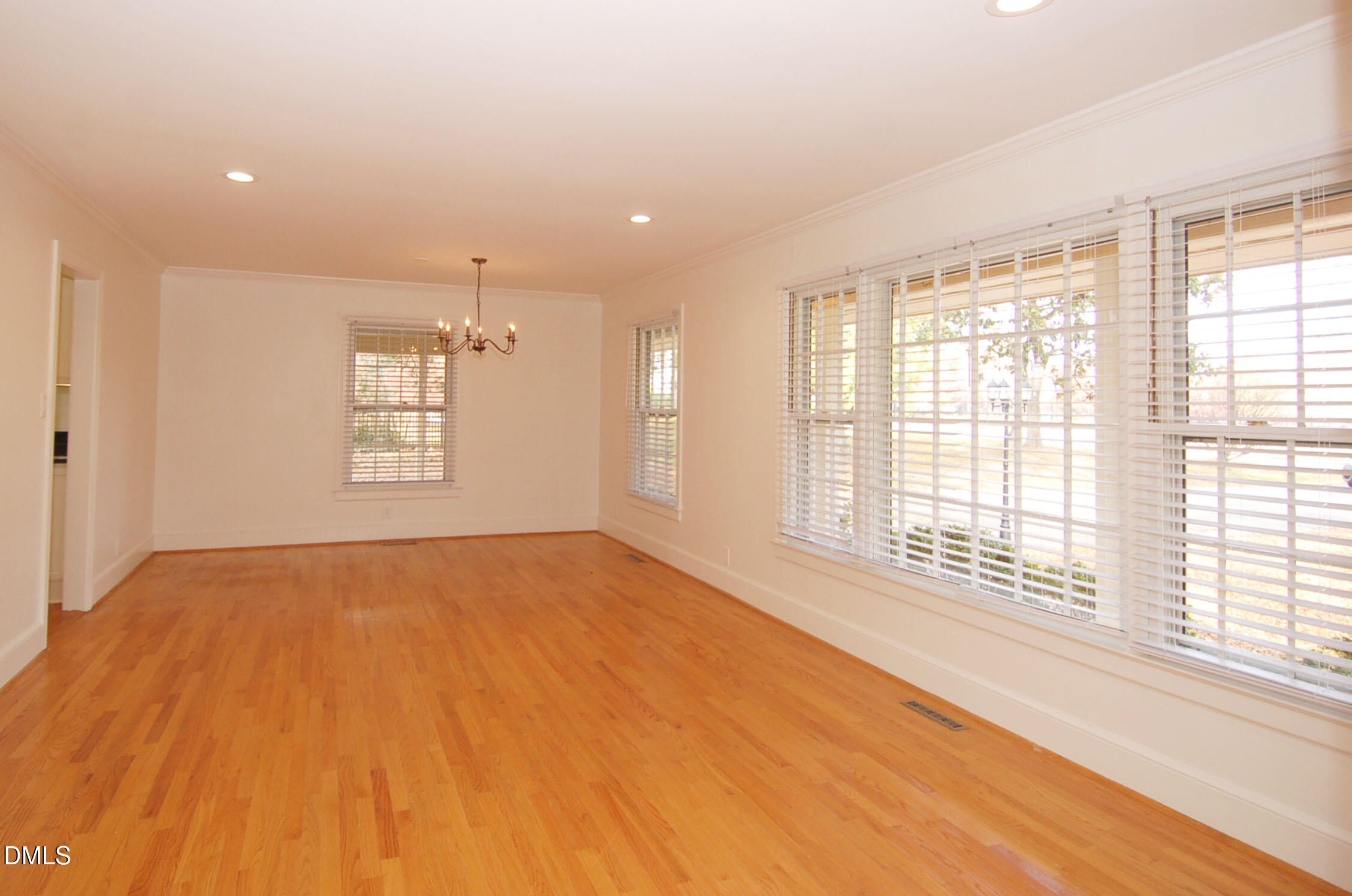 3225 Darien Drive Raleigh, NC 27607 - Photo 8 of 20 a view of an empty room with a window and wooden floor